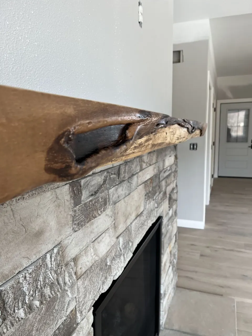 Live-edge mantel on stacked stone