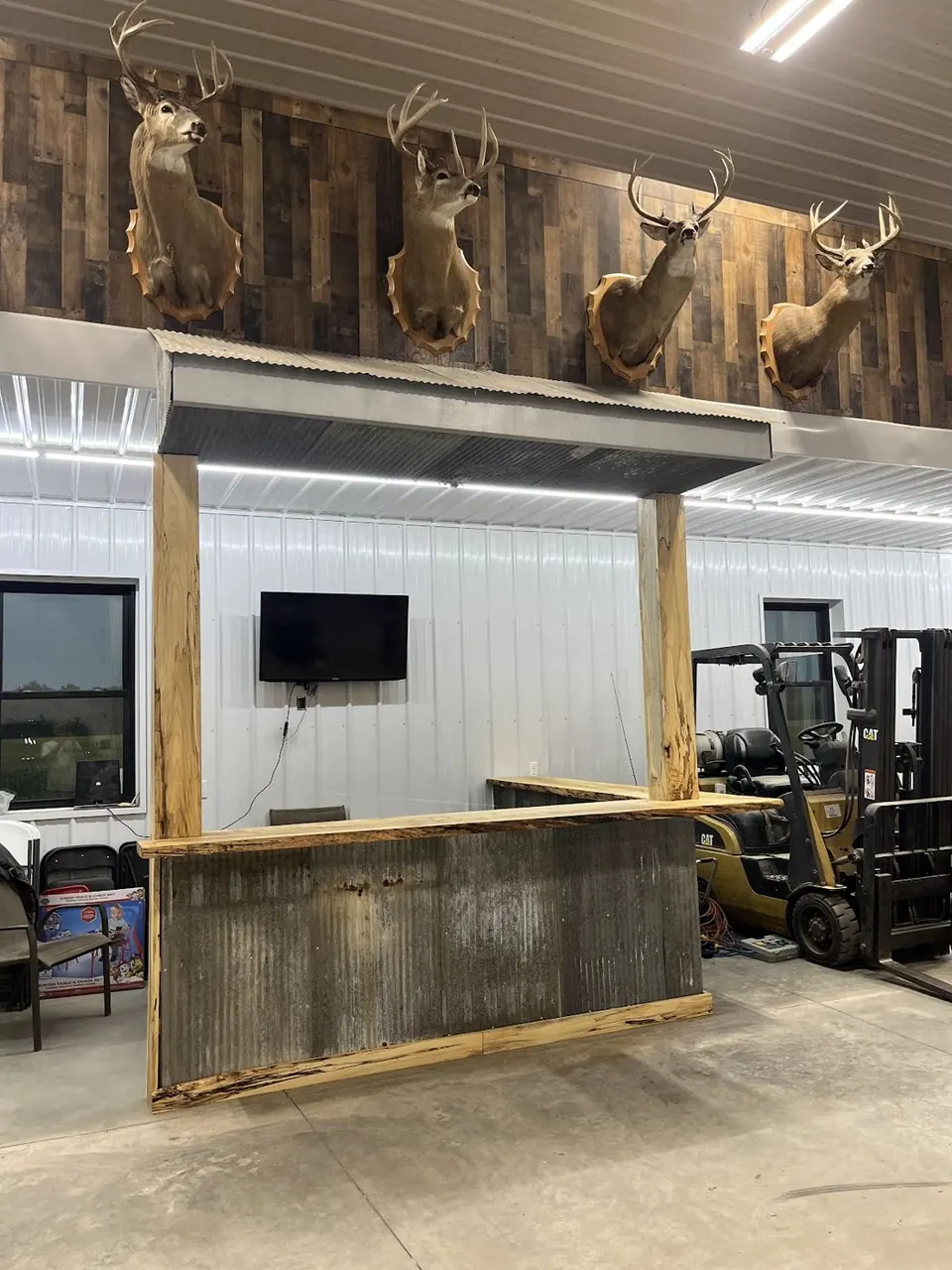 Rustic bar with deer mounts above